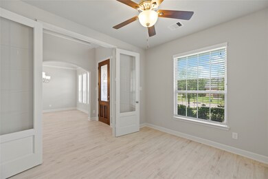 The doorway leads the way to a charming sunlit study. High ceilings and tile look like wood floor create a sleek retreat to crack open a book or your laptop. Step inside and let your home office inspire you.

