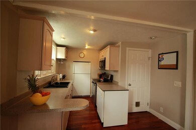 Neutral kitchen with door to basement and garage.