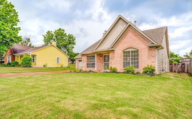 Single story home with brick siding and a shingled