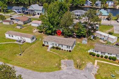 Birds eye view of property featuring a water view and a residential view