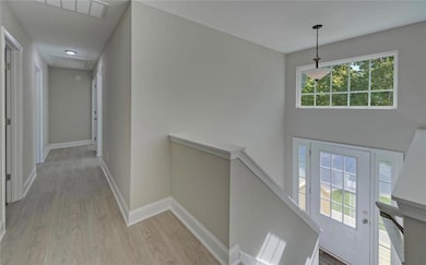 Hall featuring baseboards, an upstairs landing, at