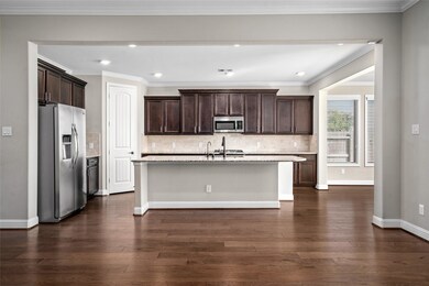 Th kitchen is modern with elegant dark wood cabine