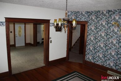 Walking thru entry into dining room. Original Hardwoods thru out with original trim and molding. 712 W Maple Sutton NE 68979, Brokered by Keller Williams Lincoln, Listed locally with Katie VanderLey, Realtor 515-450-8587