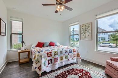 Bedroom with multiple windows, wood finished floo