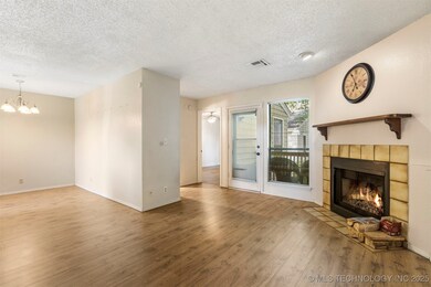 Unfurnished living room featuring a textured ceili