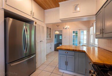 Kitchen featuring decorative light fixtures, wood 