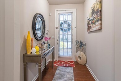 Doorway to outside with dark hardwood / wood-style