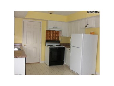 Bright cheery kitchen with range, refridgerator an