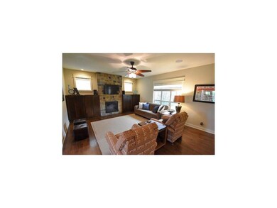 Great room with wood floors, built ins, stone fire
