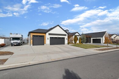 Modern farmhouse style home with driveway and an attached garage