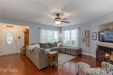 Living room with gas logs and wood floors