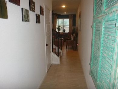Hallway with recessed lighting and baseboards