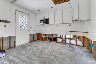 Kitchen featuring white cabinetry