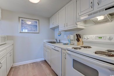 Kitchen with white appliances, under cabinet range
