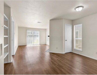 Spare room with wood finished floors, visible ven