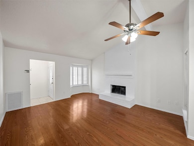 Unfurnished living room featuring wood finished fl