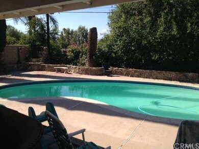 View of large swimming pool from your covered deck