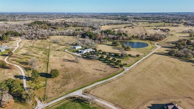 Home sits atop a 50 acre tract with pond, pasturel