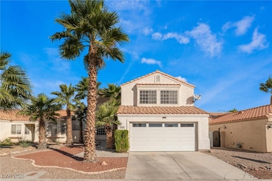 View of front facade with driveway, stucco siding,
