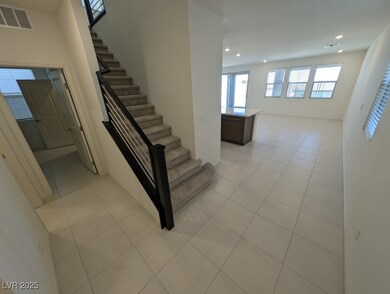 Stairs with healthy amount of natural light, tile patterned flooring, and recessed lighting