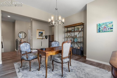 Dining room featuring a chandelier and dark wood finished floors