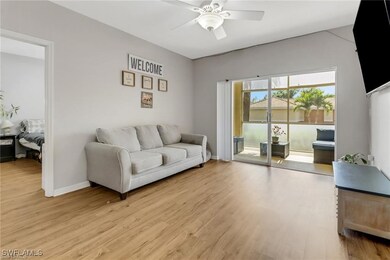 Living area with light wood finished floors, a cei