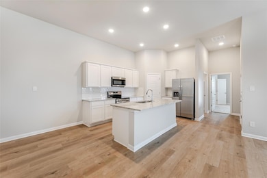 Kitchen with stainless steel appliances, a sink, 