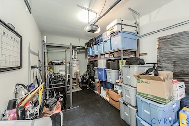 Garage with gas water heater and a garage door opener