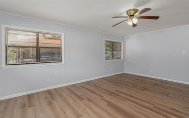 Front living room featuring ceiling fan, light har