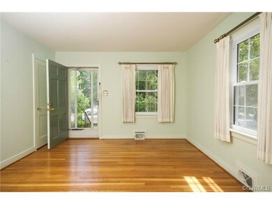 The living room has hardwood floors, coat closet, two large windows and leads to the kitchen/eating area.