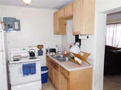 Kitchen with fridge and stove and pass through.