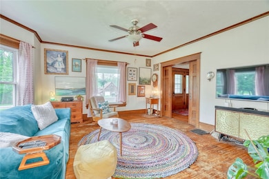 Family Room with hardwood floors, wood trim and ov