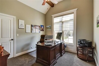 Main floor office w/ vaulted wood beams in on ceil
