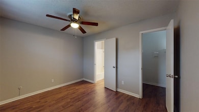 Unfurnished bedroom featuring dark wood-style floo