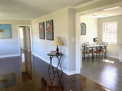 Hall with baseboards and wood finished floors
