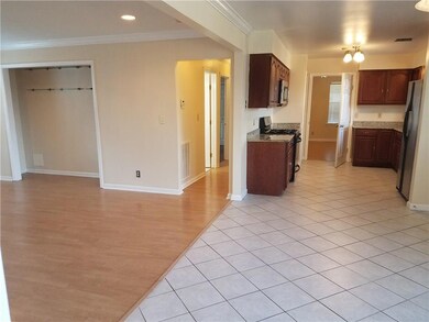 View of open area den, breakfast area, and kitchen