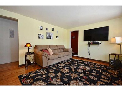 Living Room. Beautiful hardwood floors and circula