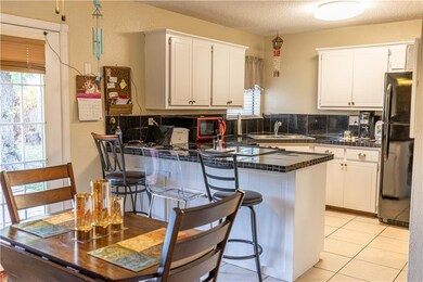 Dining and kitchen with access to backyard.