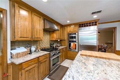 This kitchen features gas range, vent hood built-i