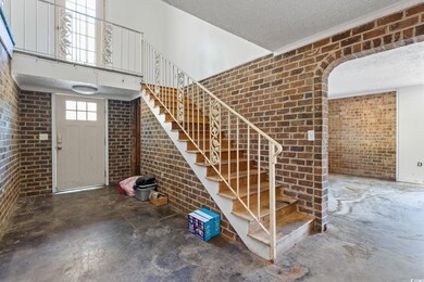 Stairs featuring a high ceiling, concrete floors, 