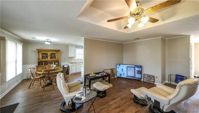 Living room featuring a textured ceiling, crown mo