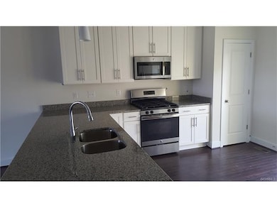 This kitchen comes equipped with a granite counter