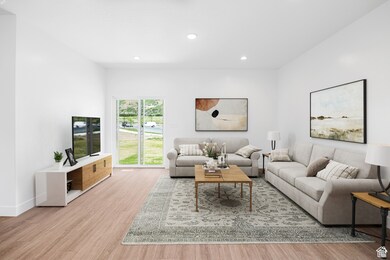 Living area with light wood finished floors and recessed lighting