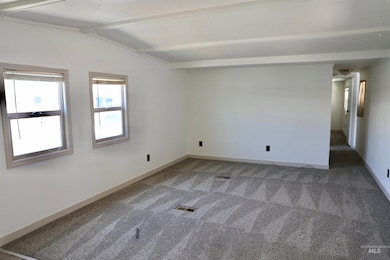 Unfurnished room with carpet floors and baseboards