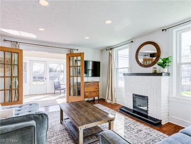 Living room featuring a fireplace, a textured ceiling, and dark wood-type flooring