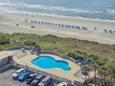 View of swimming pool featuring a patio, a water v