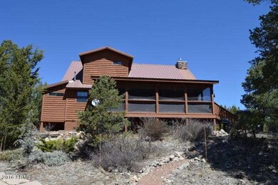 BACK OF HOME WITH A SCREENED IN PORCH
