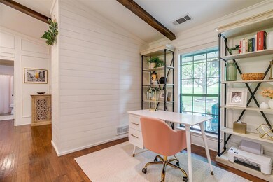 Office space with dark wood-type flooring and loft