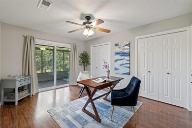 Home office with dark wood-style flooring, ceilin
