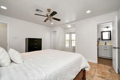 Step into luxury in the primary bedroom, where elegant tile flooring and recessed lighting create an inviting atmosphere. A ceiling fan ensures year-round comfort, while the spacious walk-in closet offers ample storage. The room's focal point is the stunning bay window, offering natural light and providing a versatile nook for reading or working from home with panoramic views to your pool!